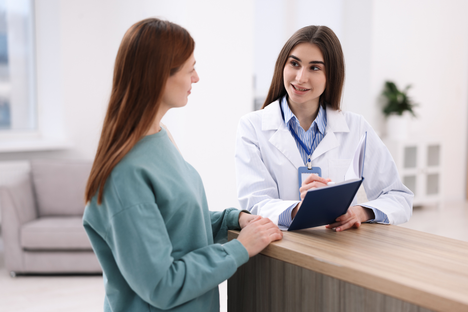 A clinician listening to a patient during an appointment